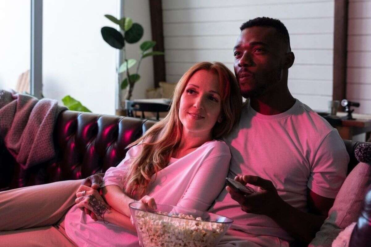 A TV screen showing Canadian IPTV channels with a remote control.